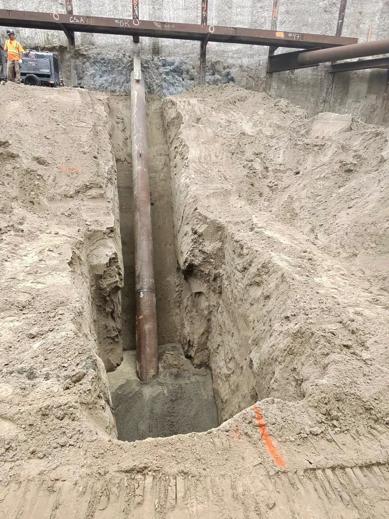 Pipe raker installed in a deep excavation against a pile-supported shoring wall
