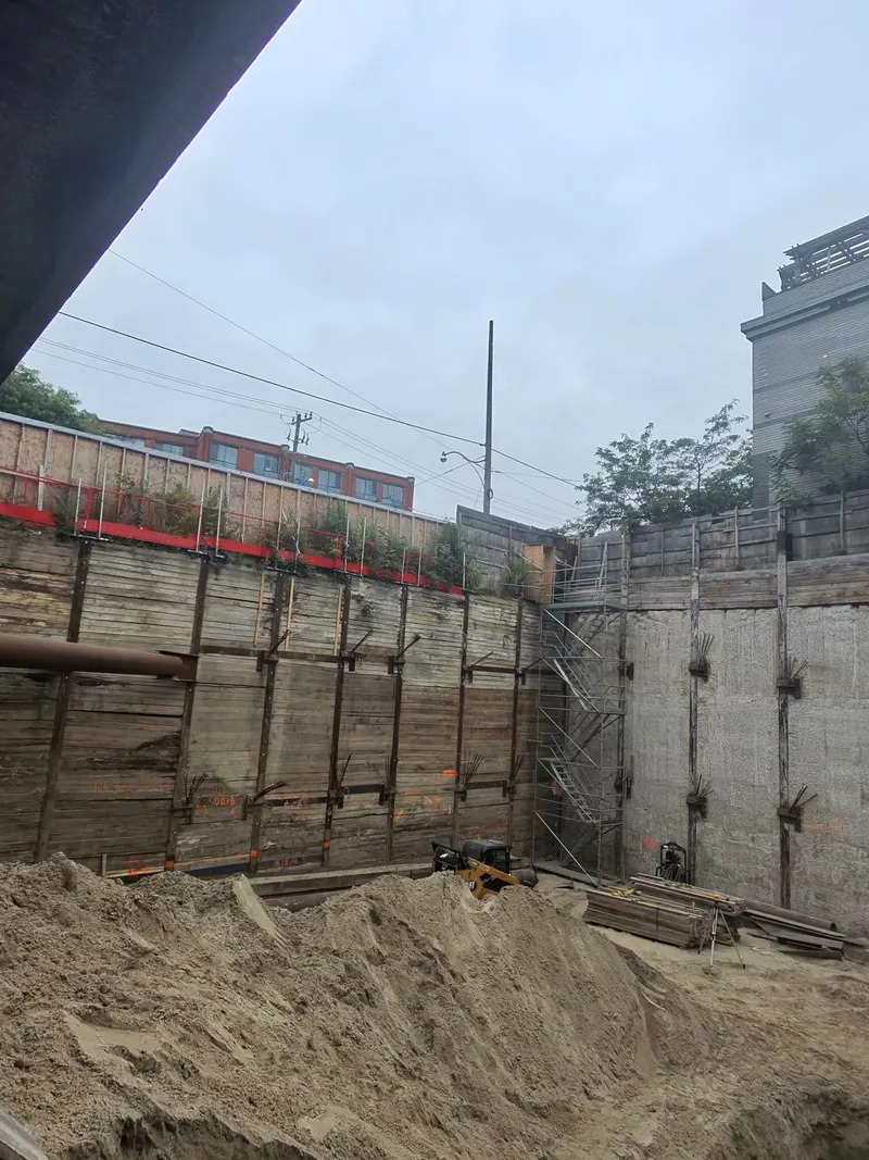Excavation shoring wall showing chairs attached to H-piles