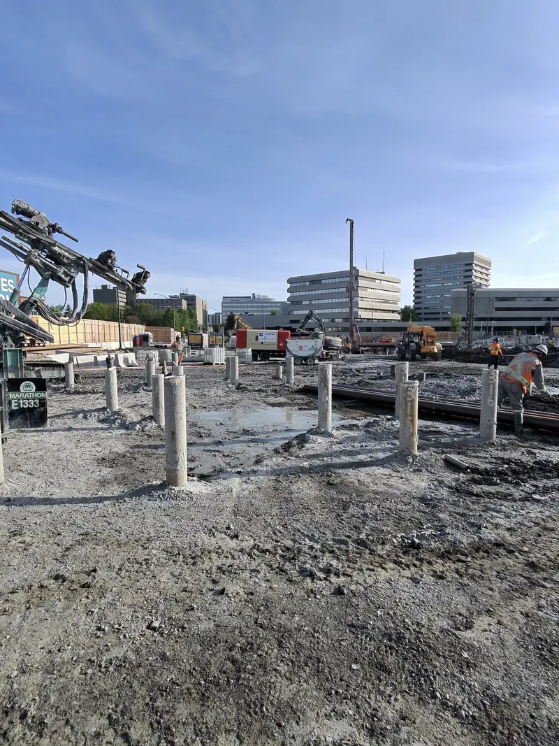 Round steel pipe piles installed at a construction foundation site