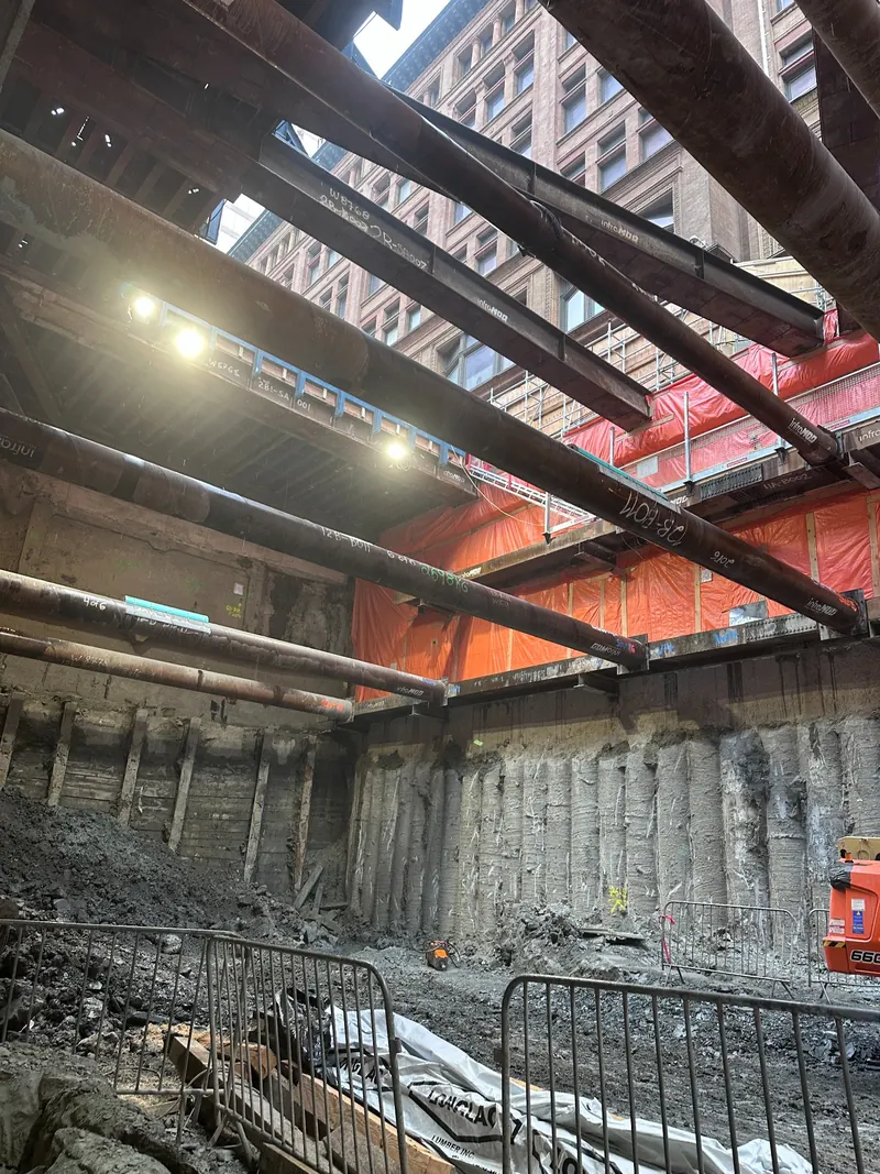 Deep excavation braced by horizontal walers and large-diameter pipe struts
